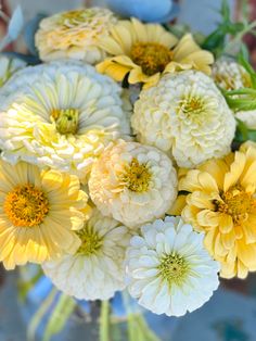 a vase filled with yellow and white flowers