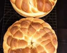 two round breads sitting on top of a cooling rack