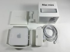 an apple mac mini with its box and charger