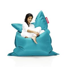 a woman sitting on a bean bag chair