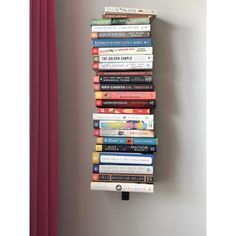 a stack of books sitting on top of a wall