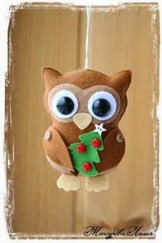 an owl ornament hanging from a string