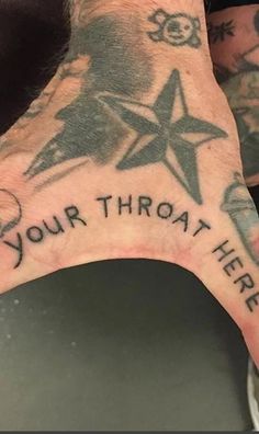 a man's hand with a star and your throat here tattoo on the palm