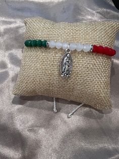 Handmade adjustable bracelet - material is nylon so one of things that are important is to keep it away from water as it can come undone  - Mexico flag themed colors & a silver virgencita charm 💕 - the perfect bracelet for you, for him, or for her 🫶 Adjustable White Bracelet Souvenir, Adjustable Spiritual Bracelets With Charms, Adjustable Rosary Bracelet With Charms As Gift, Adjustable Rosary Bracelet With Charms For Gift, Mexican Bracelets Handmade, Mexico Bracelets, Bracelet Business Ideas, Bracelet Business, Mexico Flag