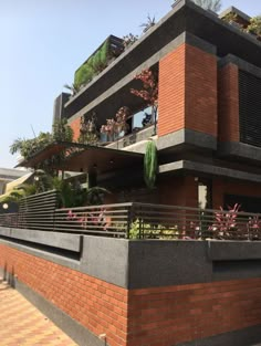 an apartment building with plants growing on the balconies