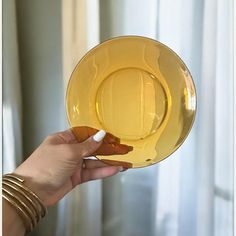 a person holding a yellow plate with a white tip