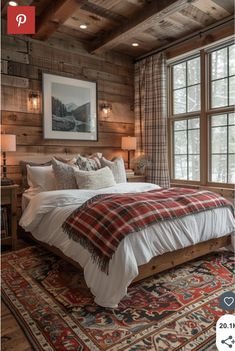 a bedroom with wood paneled walls and a large bed in front of a window