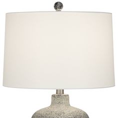 a table lamp with a white shade on it's base and a silver ball at the top