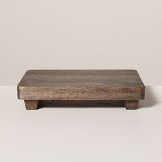 a wooden table sitting on top of a white floor