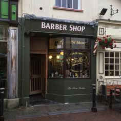 the outside of a barber shop on a city street