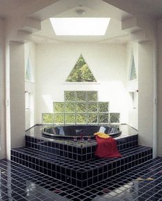 the interior of a building with black and white tiles on the floor, walls and ceiling