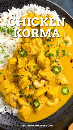 chicken korma with white rice and jalapenos in a black bowl on a wooden table