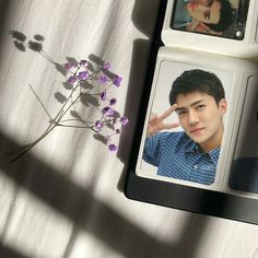 two photos are placed next to each other on a table with flowers in the foreground