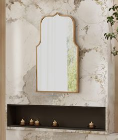 a fireplace with candles and a mirror above it