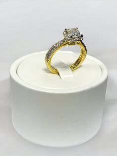 a diamond ring sitting on top of a white stand