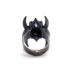 Inspired by Lord of The Rings and crown of the Nazgul. This ring pulses with dark power and raw strength. Each ring is set with a high quality black onyx. I hand texture each ring with a raw, multidirectional pattern to accentuate the stone’s physicality. Hand cast in sterling silver, oxidized and finished to 400 grit Need your size in a quarter size? Feel free to reach out before or during purchasing. *Please note: all pieces take 2-3 weeks to complete Unique Onyx Gemstone Rings, Brutalist Oxidized Open Ring, Unique Black Metal Skull Ring, Symbolic Black Open Ring, Brutalist Style Open Ring Jewelry, Brutalist Open Ring With Oxidized Finish, Brutalist Oxidized Open Ring Jewelry, Black Handmade Symbolic Rings, Handmade Symbolic Black Rings