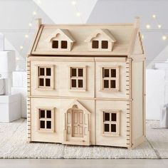 a toy house sitting on top of a white rug