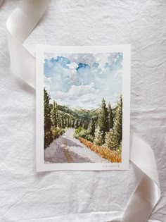 a watercolor painting of a road with trees and sky in the background on white paper