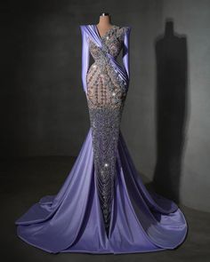 a purple dress with sequins on the shoulders and an open back, in front of a mannequin