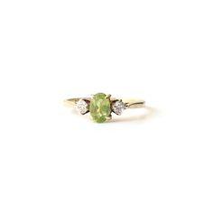 A stunning 9ct gold Peridot ring. This classic ring features a pale hued green Peridot gems flanked by two CZ stones.  This is a very eye catching ring, we do hope the photos do this piece justice. A beautiful & unique 9ct gold ring featuring August's birthstone!  This ring comes presented in a Milly's Marvel's gift box hand tied with green satin ribbon. All other boxes are for display purpose only. RING SIZE - US Size 5 3/4 UK M Hallmarks - 375 an anchor, date letter G to inside of ring shank W Classic 14k Gold Green Diamond Ring, Classic Green 14k Gold Diamond Ring, Green Hallmarked Cluster Promise Ring, Classic Green Diamond Ring In 14k Gold, Green Cluster Promise Ring, Classic Green Gemstone Diamond Ring, Classic Green Multi-stone Diamond Ring, Classic Green Cluster Ring In 14k Gold, Classic Green Ring For Promise