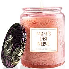 a candle that is next to a container with the lid open and it says mom's last nerve