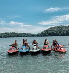 several people are riding jet skis in the water