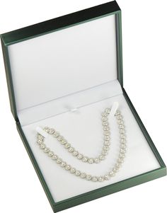 an open box with a necklace and earring set in it's display case