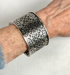 A Sterling Silver Wide Cuff made by Silpada with incredible intricate Fretwork Design in a Florentine style. The details are accentuated with a darker patina showcasing the "cut out" design. The bracelet is retired and not available from the company which still makes jewelry but no longer in this quality.  The cuff is 2" x 3", and can easily fit any wrist. It is a thick layered cuff that is malleable, it stretches out and also closes around any size arm.  Thank You for visiting HATTIE MAUDE VINTAGE.  Please reach out with any questions. We are always happy to help! Wide Cuff, Cut Out Design, Cuff Bracelets, Not Available, Jewelry Bracelets, Cut Out, Accessory Gift, Display Homes, Jewelry Making