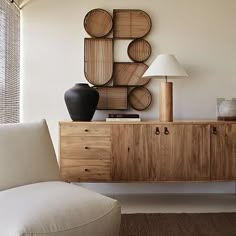 a white couch sitting next to a wooden cabinet