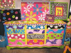 a brightly colored dresser with lots of different designs on it's sides and drawers