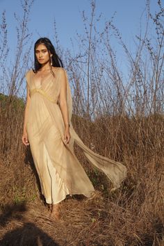 The Jala dress is a modern take on a Grecian inspired romantic feminine style. A beautifully light transparent silk dress that you can get creative layering with your favourite pieces. One Size| AUS 6 - 12 UK 6 - 12 US 2 - 8 EU 34 - 40 Fit | Will drape more on thinner frame Will drape less on fuller frame Paired with | Champagne Rose Slip Note| This fabric varies in shade when in different lights. Dress is transparent. Slip dress is sold separately Care | Please see care label for item specific Wedding Dress With Sheer Dupatta And Draped Shape, Wedding Dress With Sheer Dupatta, Silk Sleeveless Dress With Sheer Dupatta, Sleeveless Silk Dress With Sheer Dupatta, Bohemian Dress With Sheer Dupatta And Cape Sleeves, Spring Silk Dress With Sheer Dupatta, Ethereal Sheer Dresses For Summer, Silk Summer Dress With Subtle Sheen, Delicate Sheer Evening Dress