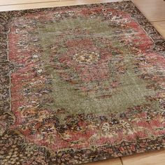 a large area rug with an ornate design on the top and bottom in various colors