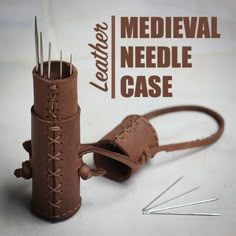 there is a leather needle case with needles in it and the words, medieval needle case