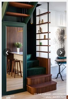 the stairs in this house are made from wood and have green velvet upholstered them