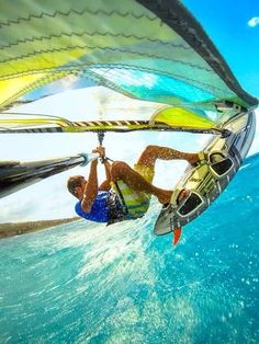 a man riding a kiteboard on top of the ocean