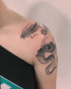 a woman with a dragon tattoo on her shoulder