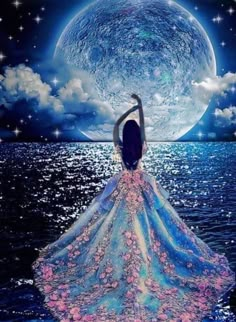 a woman is standing in the water with her arms up and looking at the moon