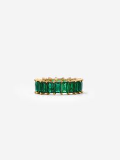 This gold eternity ring with emerald green stones is perfect for adding a pop of colour to your everyday outfits this season.  Wear it alone for a minimalistic look or stack it with our popular eternity ring for an extra sparkle: https://www.etsy.com/uk/listing/874164678/gold-eternity-ring-white-cubic-zirconia 𝗚𝗢𝗢𝗗 𝗧𝗢 𝗞𝗡𝗢𝗪 Forget the fear of tarnishing, skin irritation or green staining; you deserve better than that. We work with only the finest 18 Carat Gold and Sterling Silver which Formal Green Half Eternity Jewelry, Fine Jewelry Green Emerald Half Eternity Ring, Classic Green Gemstone Eternity Band, Green Emerald Half Eternity Ring Fine Jewelry, Green Emerald Ring With Half Eternity Style, Classic Green Eternity Promise Ring, Classic Green Half Eternity Band, Green Cubic Zirconia Crystal Ring For Anniversary, Formal Green Gemstone Eternity Band