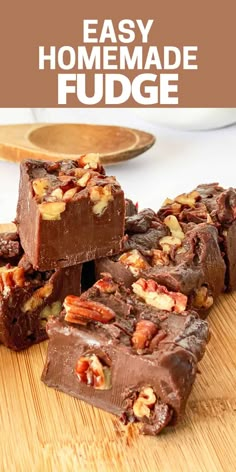 chocolate fudge bars stacked on top of each other with pecans in the background