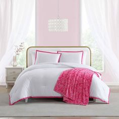 a bedroom with pink walls and white bedding