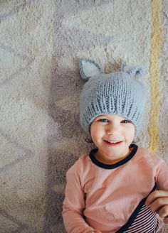 Our sweet bunny hat is perfect for new spring babes. These have a nice fit around the base of the hat that keeps it from getting stretched out. The color in the ears is such a simple but cozy detail. Bailey Bunny comes in three different colors: choose between White with Gray ears, White with Pink ears or Gray with White ears. Any color you decide will have you ﻿hopping﻿ with joy. Photo by: @andrea.coonrod Playful Knit Hat One Size Fits Most, Playful Knit Hat One Size, Cute Winter Hats With Ears, Playful Knitted Bonnet, One Size, Playful Knit Beanie, Playful One-size Knitted Hat, Playful Warm Bonnet Cap, Playful Warm Knit Beanie, Playful Hand Knitted Hat