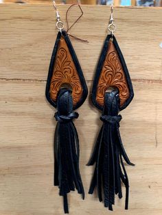 Hand carved earring that have been antiqued for a old look black died edges with black calf skin fringe Black Hand-tooled Bohemian Jewelry, Black Hand Tooled Bohemian Jewelry, Black Bohemian Hand-tooled Jewelry, Traditional Black Tassel Earrings, Artisan Black Dangle Earrings, Handmade Black Leather Earrings, Ear Weights, Textile Jewelry, Fabric Textile