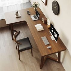 a wooden desk with two chairs next to it and a clock on the wall behind it