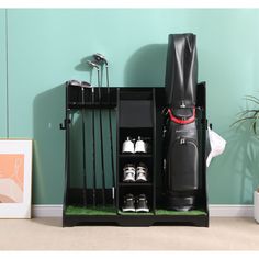 a black suitcase and some shoes in a room with a green painted wall behind it