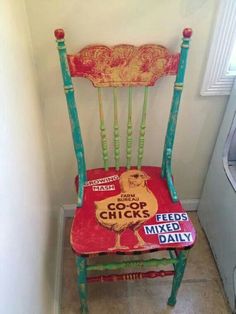 a red and green chair sitting next to a white wall