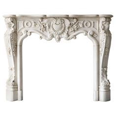 a white marble fireplace mantel with carvings on the top and sides, in an ornate manner