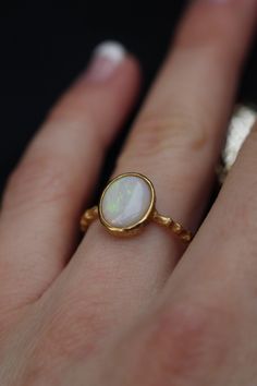 Opal ring, dainty opal gold filled ring for women. High quality Australian opal. Nice present for her. Available of different materials: -Rhodium plated sterling silver* -18k gold filled sterling silver -18 solid gold *Rhodium layer is used to make silver shine for a long time. Please, make sure you don't have allergy on rhodium. Size:  Please, choose the size you need. We use US sizes from 5-10. Our Ring Guide will help you to find the right size. If you don't see your size on the list or you h Large Opal Ring, Fine Jewelry Opal Oval Cabochon Ring, Fine Jewelry Opal Ring Oval Cabochon Birthstone, Handmade Oval Opal Ring Fine Jewelry, Dainty Opal Cabochon Jewelry, Handmade Oval Opal Ring In Fine Jewelry Style, Opal Birthstone Ring In White Gold, Heirloom Style Opal Ring Gift, Minimalist Opal Ring With Bezel Setting As Gift