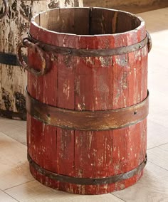 an old wooden bucket sitting on the floor