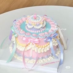 there is a cake that has been decorated with ribbons and bows on top of it