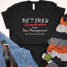 a black shirt that says retired under new management and some shoes to wear with it